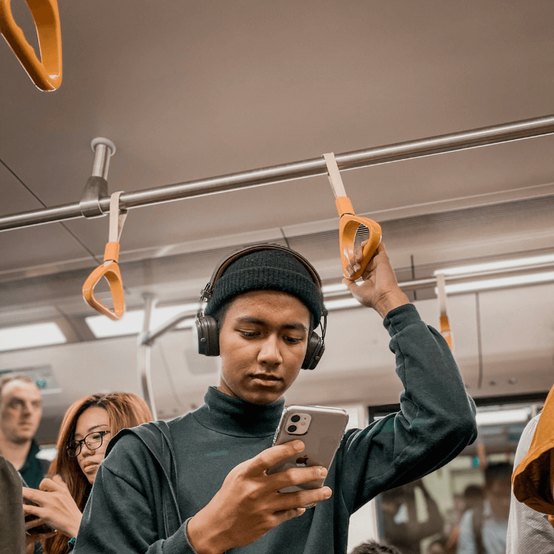 boy looking at phone in public transport