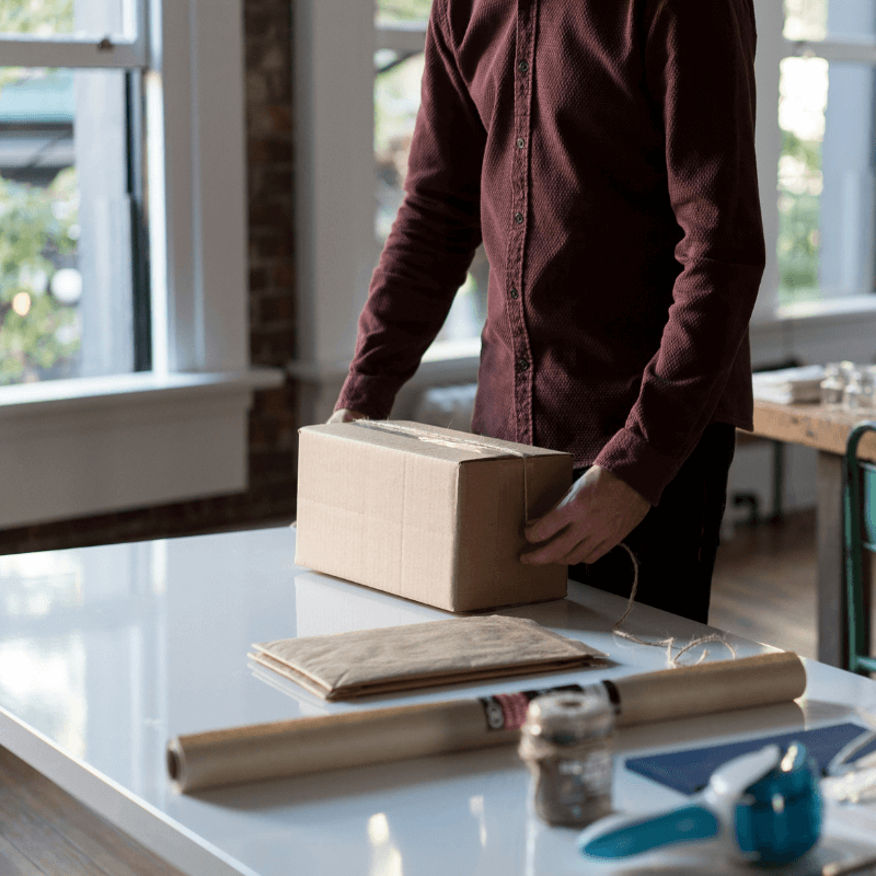 man packing package to be shipped out